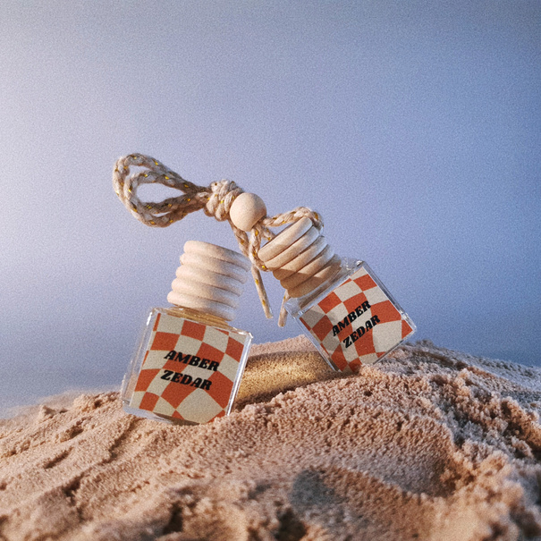 Charmeau Amber Zedar - perfume bottles sitting on beach